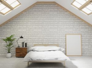 Loft with skylights and white brick walls